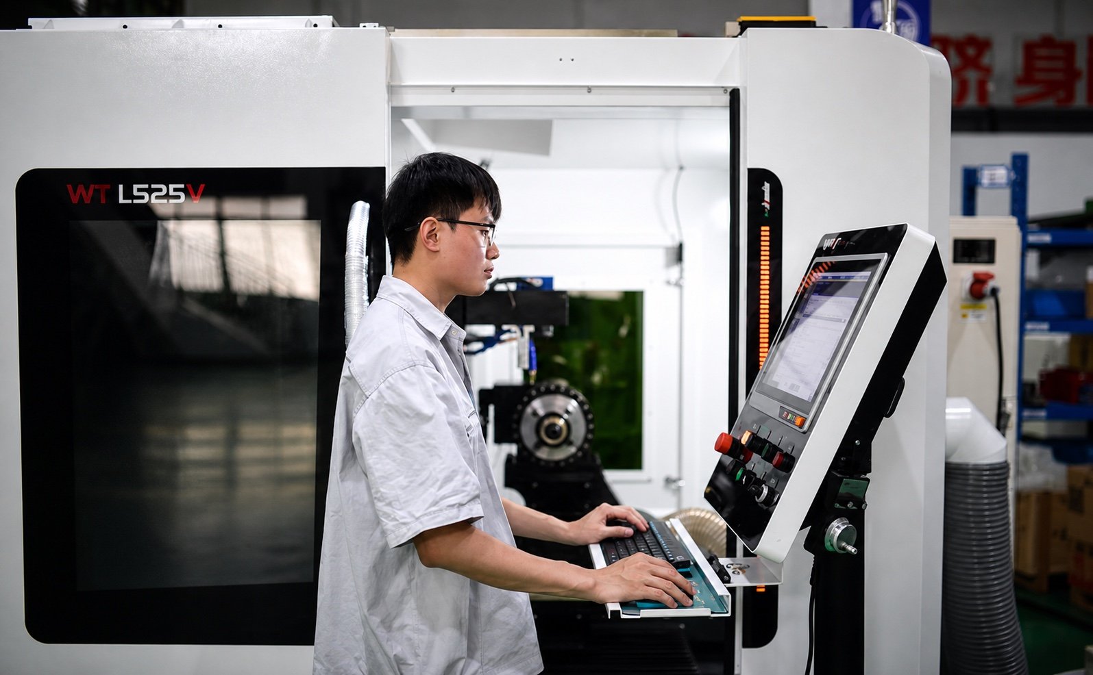 Technician operating a CNC machining center