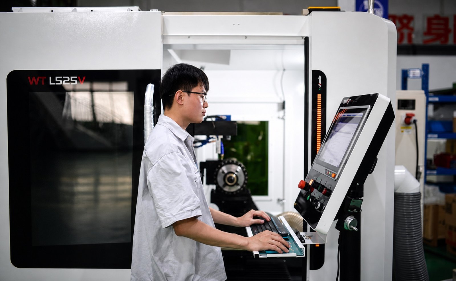 Technician operating a CNC machining center